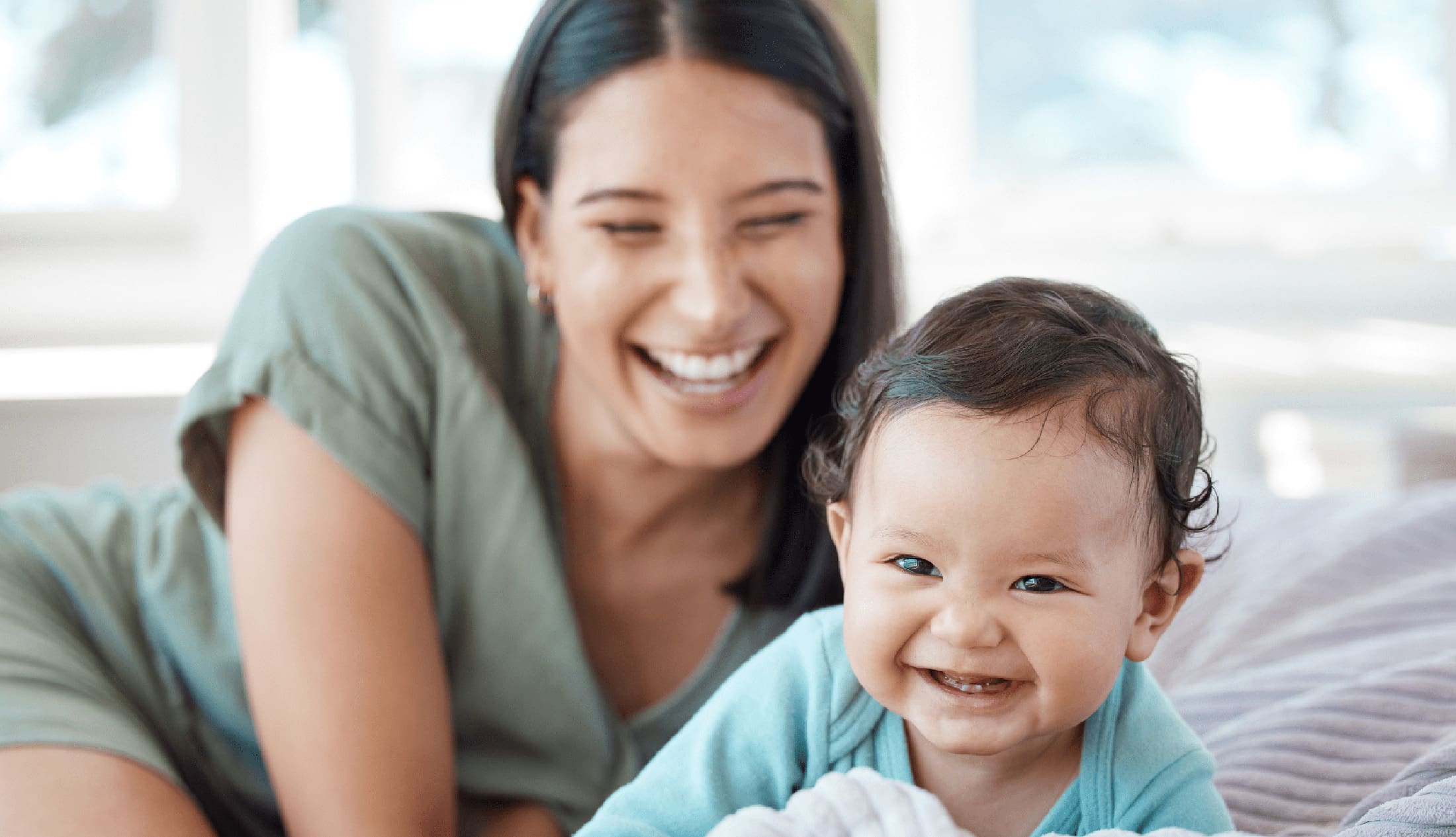 A mother enjoying her child growing up and reach her development milestones.