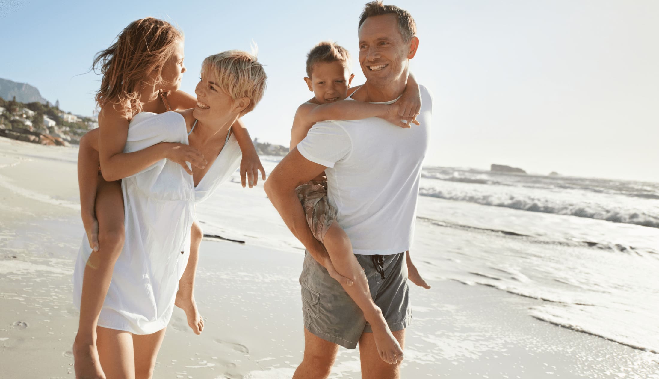Parent on on the beach with their children during a holiday
